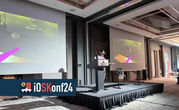 Showing the Vision Pro at a conference podium. Two huge displays behind me display AirPlay live stream